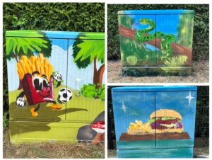 Drei bunt bemalte Stromkästen mit Motiven aus Natur, Essen und Sport.